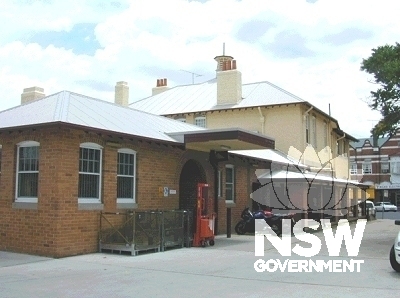 View looking north of Inverell Post Office showing later sorting and storage brick addition in the foreground and the original two-storey building in the background.