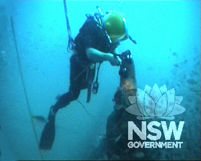 M24. Royal Australian Navy clearance diver (AUSCD1) filming down periscope standard, at remains of conning tower. Archaeological surveys conducted in May 2007.
