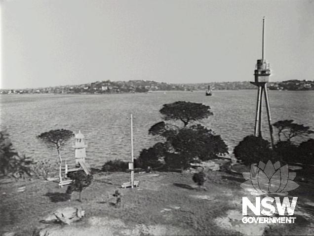 The H.M.A.S. Sydney I mast in 1936, two years after installation. To the left is the the offshore electric beacon and foghorn, erected in 1905 and originally powered by submarine cable from the Fort Macquarie electric light station.