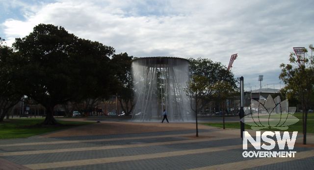 Cauldron, Sydney Olympic Park, viewed from south west with two children's playgrounds in background.