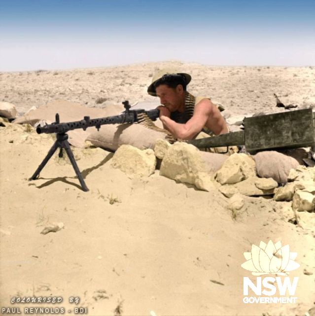 'First Battle of El Alamein'. An Australian soldier, possibly from 26 Brigade, 9th Division (Australia) with a captured German MG.34 in a machine gun post near the strategic high ground around Tel el Eisa, north-west of Alamein, Egypt. 25th of July 1942. 