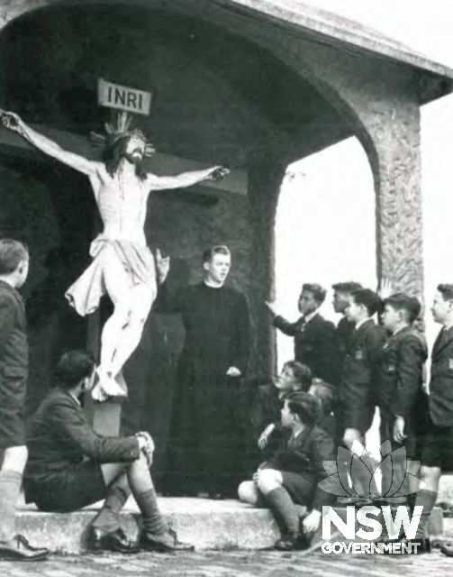 Undated photograph showing a Christian Brother teaching boys with the Limpias Crucifix. The crucifix is a copy of a venerated example in the Spanish town of Limpias and was sent to Mount St. Mary’s by the Christian Brothers of Gibraltar to mark the 1,900t