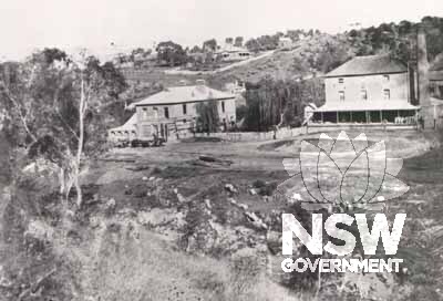 The flour mill, with Budden's half competed store to left. -1872.
