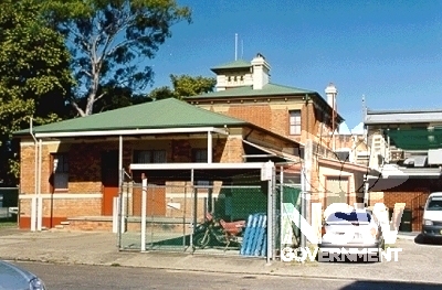 Rear view of Kempsey Post Office looking west, showing 1927 brick addition with recent loading dock and carport in the foreground.