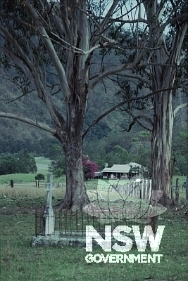 View of Kunderang Station and cemetery. The homestead is architecturally significant as the only known pit sawn Australian red cedar plank house constructed as late as 1892. It is the only one surviving on the coast of New South Wales.