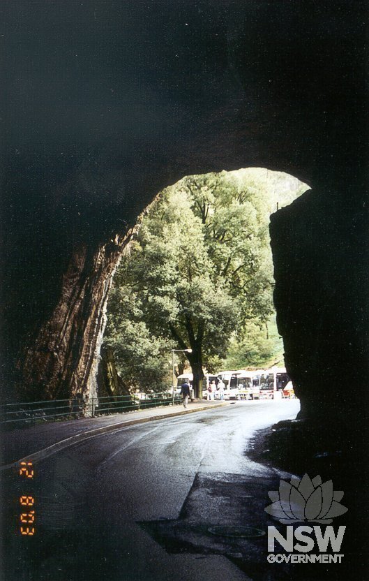 Roadway into the caves hamlet as it passes through the Grand Arch to reveal view towards Caves House across open square.