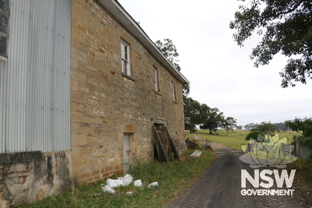 Southern wall of the former granary/coach house/store and view of the entry drive.