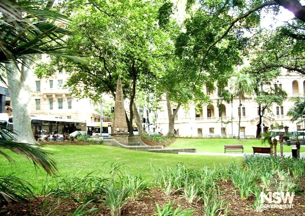 Macquarie Obelisk and Macquarie Place (Bridge Street in background), with two London Plane trees planted in 1954 by the Queen. These trees mark the beginning of the Remembrance Driveway to Canberra. View from junction of Macquarie Place and Loftus Street.
