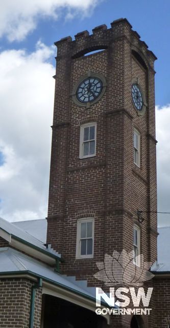 Detail of the Wingham Memorial Town Hall clock tower viewed from the corner of Farquhar and Queen Streets.