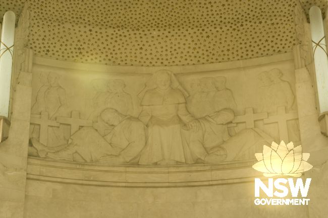 ANZAC Memorial interior - carved relief of nurse with wounded soldiers topped by golden Stars of Memory