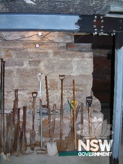Structural supports (J bars) in new sub-floor cavity in norther-eastern corner of cathedral.  Remains of original white marble floor showing to right of light & to left of black horizontal beam. Saints Peter and Paul Cathedral, Verner Street, Goulburn (Ap