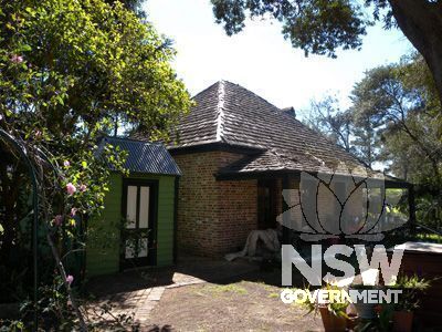 Denham Court house - 1982 brick games room built in Victorian Georgian style with timber shingled roof, with 1850s timber toilet block built for Miss Lester's School for Girls in the foreground