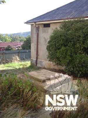 The well and southern end of the later 1881 Cell Block Wing in the background.