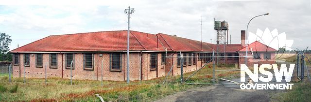 Panoramic view of the back of Ward 21, taken through the locked gates in the north-west wall of the Maximum Security unit, two years after its closure in 1990. Note the steel mesh grid bolted over all windows. (Doring Negs.407.32a, 33a, 34a, merged)
