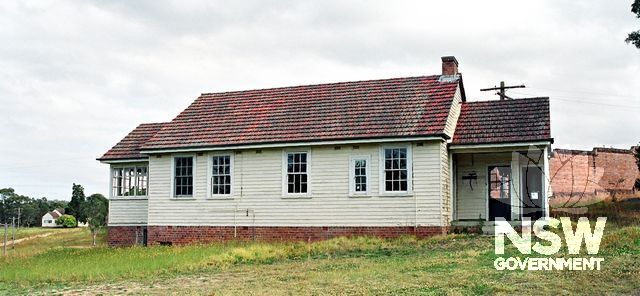 Staff Residence No.22 (Eckford Bldg.No.78), outside the perimeter wall of the Maximum Security compound. The prison wall can be seen and Staff Residence No.25 (Eckford No.81), outside the east corner of the wall (Doring Neg.407.36a)