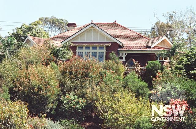 The Knoll, photographed from The Esplanade to the south in 1992. The garden plantings were recent, and were growing rapidly to hide the house from view. (Doring Neg.417.09)