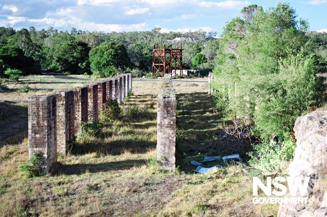 West Wallsend No.1 Colliery Site. View north along the 3 rows of coal box piers to the headframe base.  Earthworks for the new Freeway can be seen in the background above the headframe. (Doring Neg.304.03) (See also Supplementary Images)