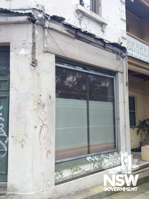 Original timber framed shop window with aluminium security screen at 60 Illawarra Road