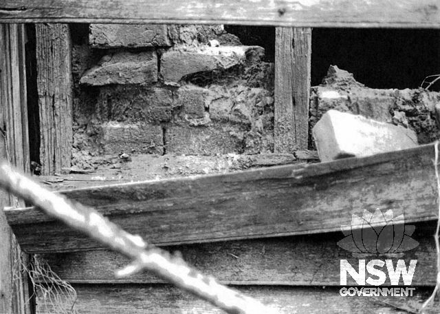 Ravenswood, 1991. Brick nogging beneath outer weatherboard of old residence. From west.