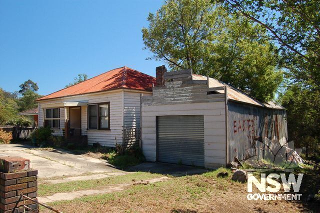 Example of traditional wall cladding and roof detailing on a garage beside a weatherboard cottage (roller door is an unsympathetic replacement).
