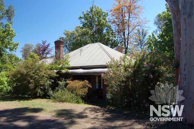 Traditional cottage type: single storey, galv roof, chimney, steep roof pitch, small building footprint. These are all elements that should be retained and protected.