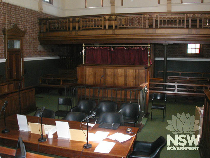 The courtroom in Cootamundra Courthouse, showing the ornate public gallery and prisoner dock.