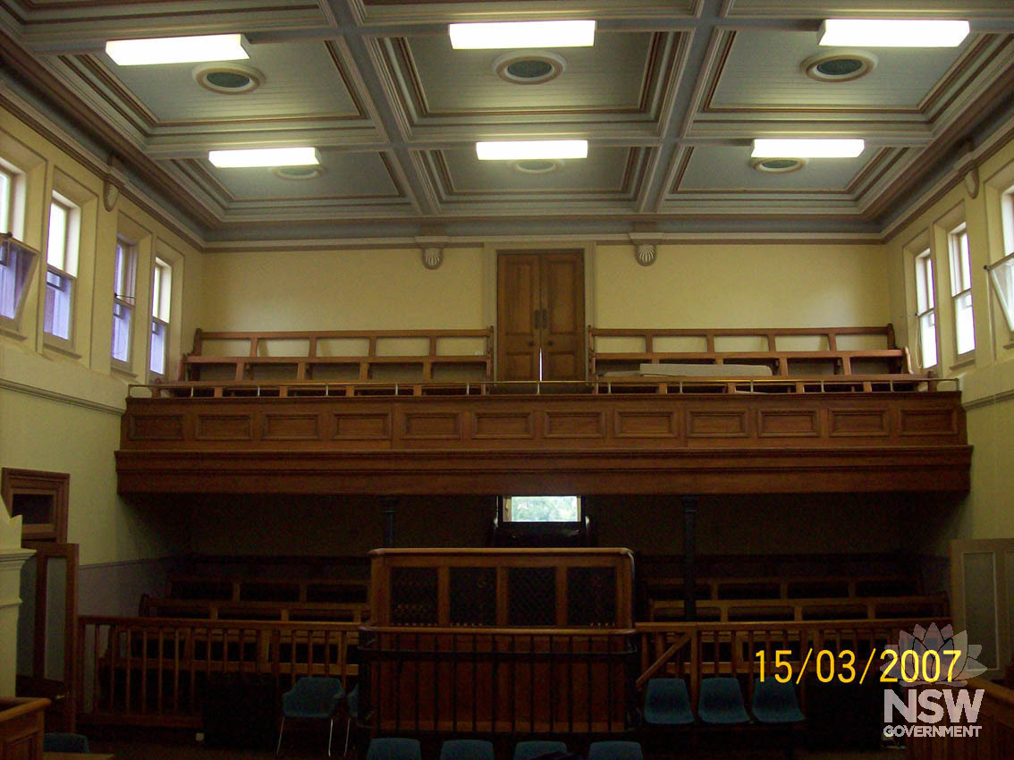 The courtroom in Cooma Courthouse, showing the public gallery and prisoner dock.