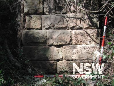The west side of the culvert on Old Windsor Road south of Meurants Lane.  Note the clay pipe in the lowest course beneath the range pole.