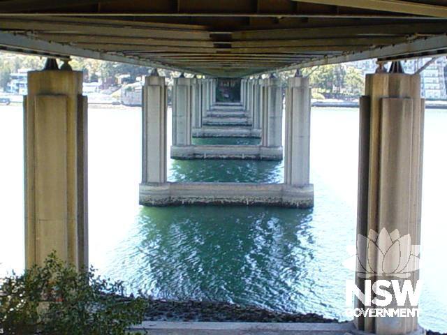 The piers built at Iron Cove Bridge with their Art Deco inspired vertical fins mark a singular removal from the octagonal cross-sectioned piers that were in general use for large steel truss structures.