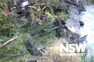 View downstream showing old timber abutment and fallen concrete headstock from previous bridge