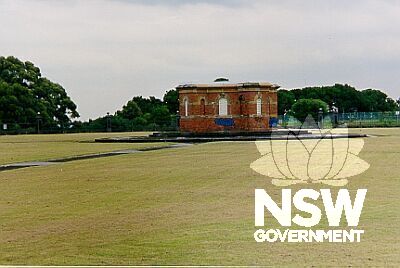 The brick and sandstone access building in the centre of the Centennial Park Reservoir.