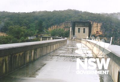 The walkway on the Nepean Dam wall.   In the centre is the Upper Valve House.