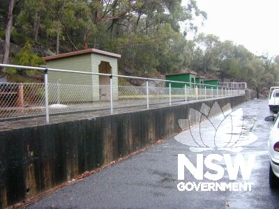 An old train platform on the Nepean Dam, which now has small picnic huts on its length.