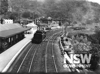 Hawkesbury River Station Group - View of Hawkesbury River station from footbridge looking south. The island platform is at left with signal box at far end of building.  c.1956