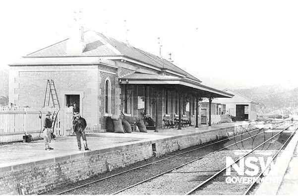 Eskbank Railway Station c.1885. Note the gas lights and brackets on the wall of the station and the original sandstone capping of the platform wall.  Goods shed in the background.
