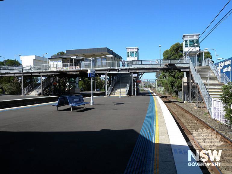 Carlton Railway Station - c. 1930s steel pedestrian footbridge/stair structure, modern overhead booking office, lifts