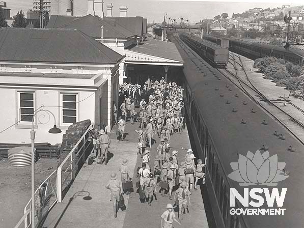 School children preparing for the arrival of Queen Elizabeth 11 at Wagga Wagga Railway Precinct- view of track side, 1954.