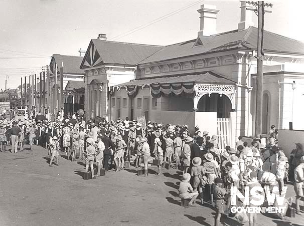 School children preparing for the arrival of Queen Elizabeth 11 at Wagga Wagga Railway Precinct- view of approach side, 1954.