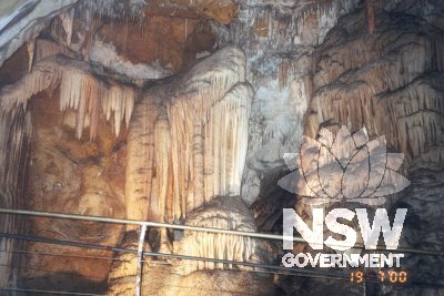 Cave formations in the Chifley Cave, with metal pipe and wire handrails for visitors