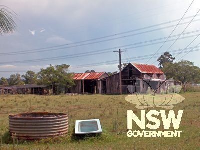 Outbuildings  from north.  1930s dairy at left, main slab shed group on right
