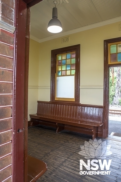 Hawkesbury River Railway Station Group - Bench seats and coloured glass windows in the waiting room
