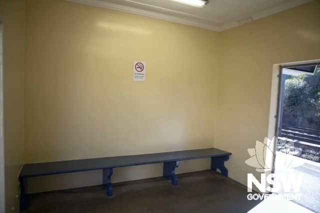 Dulwich Hill Railway Station Group - Waiting room interior with bench seats.