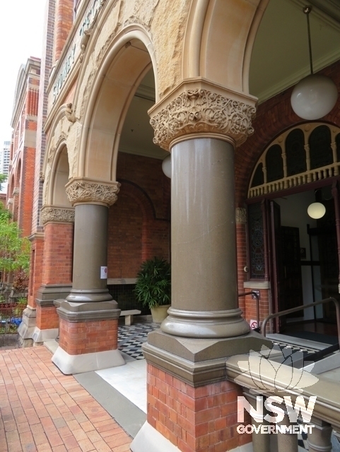 Building A: Trachyte and sandstone entrance porch arches to the main entry from Mary Ann Street