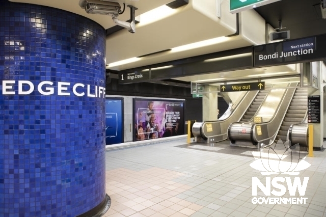 Edgecliff Railway Station - Tiled pier with signage and escalators to exit.