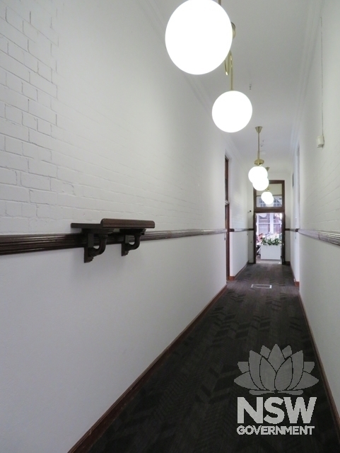 Building A: Main east-west corridor on the 1st Floor with painted brick walls (non-original colours)