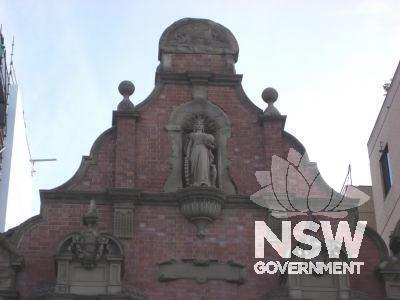 Facade detail - elaborate central gable with statue of Commerce