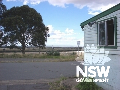 View from the site to the north-east, looking down across the flat land beside the Hunter River. The building at the right hand side of the picture is the gate house.