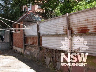 Lennox House. Fence and smaller brick outbuilding to south of house, at southeast property boundary.