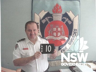 The No. 10 plate with Superintendent P. Stathis and the emblem of the NSW Fire Brigade.