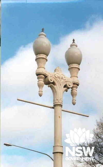 Detail of one of the Bathurst street lamps, showing the Art Deco twin lamp bulbs atop the Victorian cast iron base